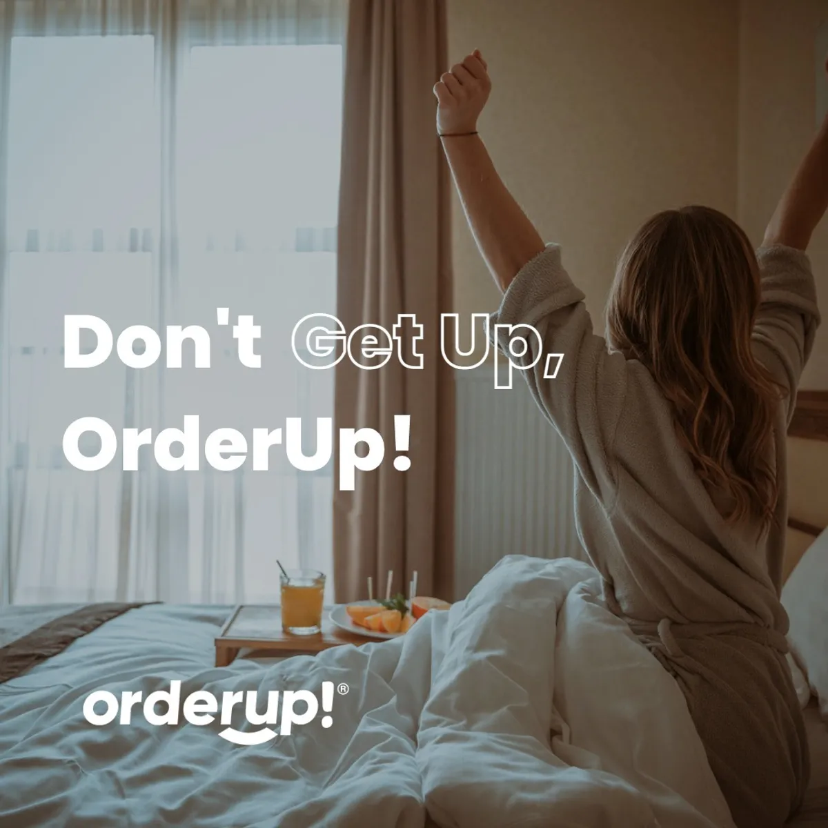 OrderUp “Don't Get Up, OrderUp!” promo of a woman stretching in bed beside a room-service tray